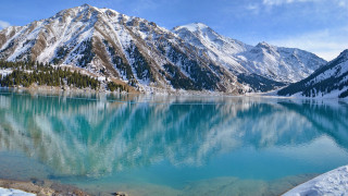 Mountain range lake reflection snow - snow covered mountains free wallpaper