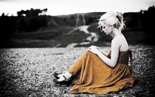 Woman sitting ground legs crossed 16 - a brown dress free wallpaper