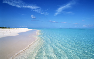 Beach clear blue water sandy - a boat in the distance free wallpaper
