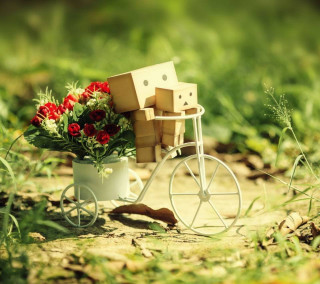 Small cart flowers boxes grass - a tilt shift photo free wallpaper for tablet