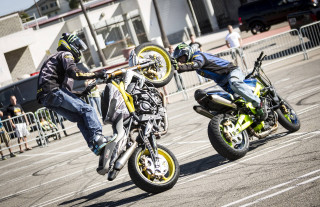 Motorcycle tricks parking lot audience - two person free wallpaper