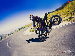 Man motorcycle trick road hill - a trick free wallpaper