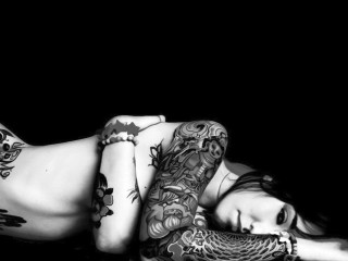 Tattooed woman bed gothic art - her arm and legs free wallpaper