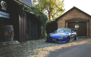 Blue sports car brick building - scenery free wallpaper
