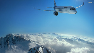 Plane flying mountain range clouds - cloud below free wallpaper