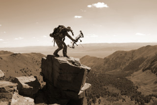Man backpack bow rock mountains - a rock free wallpaper for desktop