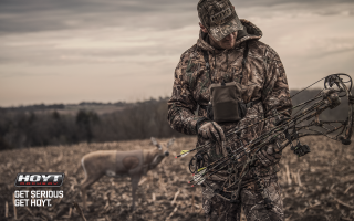 Man camouflage bow deer field - a cloudy sky in the background free wallpaper for desktop