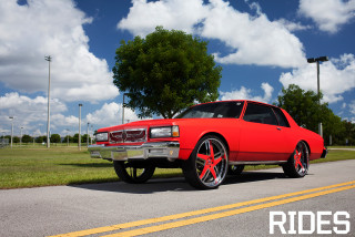Red car parked road grass 2 - rich vivid color free wallpaper