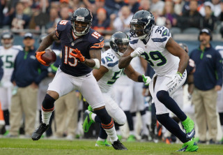 Football player running ball another - a football player running free wallpaper