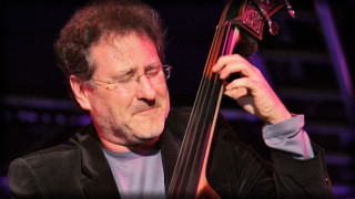 Man holding bass serious look - right free wallpaper