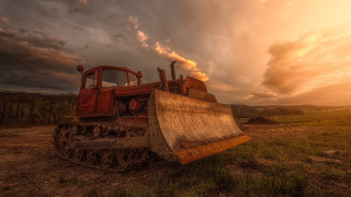 Tractor parked field cloudy sky - a tractor free wallpaper