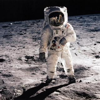 Astronaut walking moon foot ground - free space wallpaper for tablet