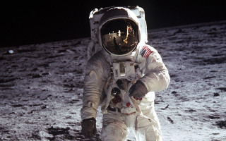 Astronaut walking moon helmet glove 2 - free space wallpaper