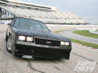 Black car stadium bleachers track - a car in the background free wallpaper