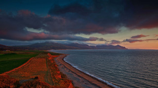 Beach water mountain clouds sky - rich moody colour free wallpaper