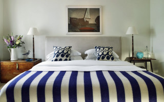 Bed blue white blanket lamps - side of it free wallpaper