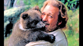 Man holding monkey smiling camera - a monkey free wallpaper