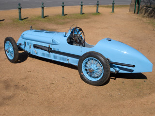 Blue racecar dirtfield fence streetsign - top of a dirt field next free wallpaper