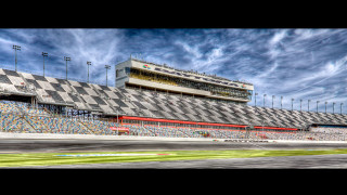 Race track checkered finish building - a tall building in the background free wallpaper