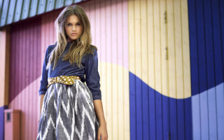 Woman standing colorful building suitcase - free retro wallpaper for desktop