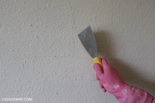 Person holding spatula yellow handle - white paint free wallpaper