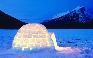 Igloo lit snow night mountains - ecological art free wallpaper