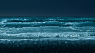 Dark blue ocean waves crashing - a dark sky in the background free wallpaper