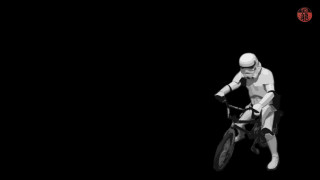 Man riding bike black background - a helmet free wallpaper