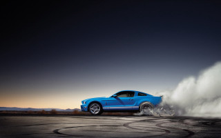 Blue mustang driving dusty road - dust free wallpaper