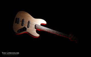 Bass guitar closeup black background - product photography free wallpaper