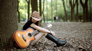 Woman sitting guitar cowboy hat 3 - a guitar free wallpaper