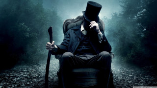 Man top hat coat sitting 2 - a man in a top hat free wallpaper