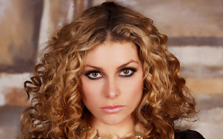 Woman necklace black shirt pose - a painting behind her free wallpaper