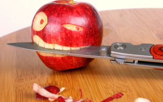 Knife cutting apple face background - cutting free wallpaper