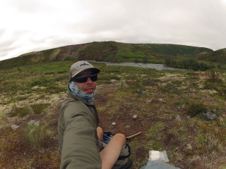 Man sitting rock field mountain - ultra free wallpaper