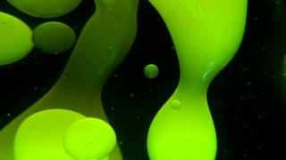 Green liquid flowing black surface - bubble free wallpaper for desktop