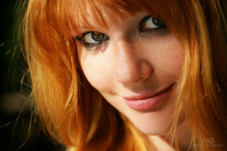 Redhair greeneyes freckles cellphone portrait - her hand and a cell phone free wallpaper