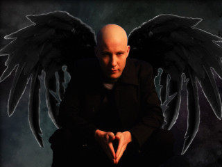 Bald man black wings sitting - a bald man free wallpaper