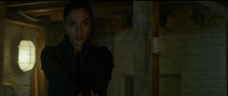 Woman black coat holding gun - a gun in a room free wallpaper