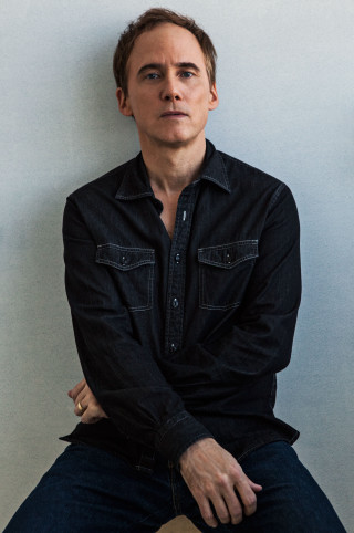 Man stool hands hips serious - studio portrait free wallpaper for mobile