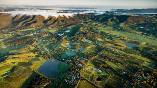 Green field mountains water view - aerial view free wallpaper for desktop