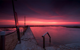 Sunset water dock red sky - a red sky in the background free wallpaper for desktop