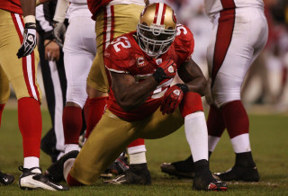 Football player kneeling field hands - his foot free wallpaper