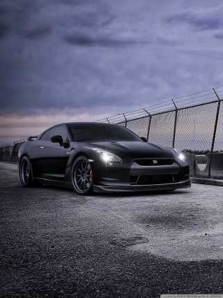 Black sports car fence night - a chain link fence free wallpaper for mobile