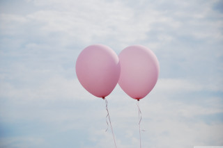 Pink balloons floating sky background - free happy birthday wallpaper