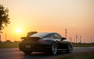 Black sports car sunset road 6 - a black sports car free wallpaper