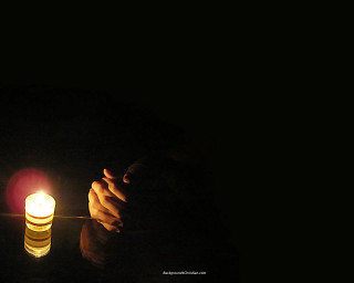 Person holding lit candle dark - their hand in free wallpaper