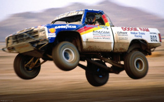 Truck jumping mountain sky background - a truck free wallpaper for desktop