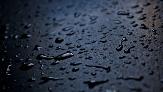 Water droplets black surface dark - a black surface free wallpaper
