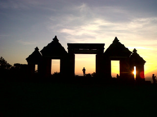 Buildings field sunset people distance - the sun setting behind them free wallpaper